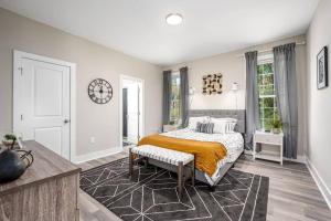 a bedroom with a bed and a clock on the wall at Cozy Ranch New Build 3 bed 2 bath in Durham