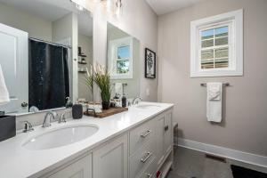 a white bathroom with two sinks and a mirror at Cozy Ranch New Build 3 bed 2 bath in Durham +37 photos