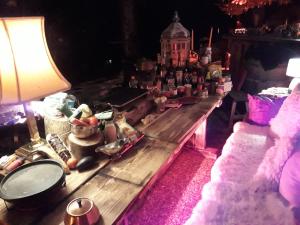 a room with a table with food and a lamp at Chalet Chnorz Hosted in Nesslau