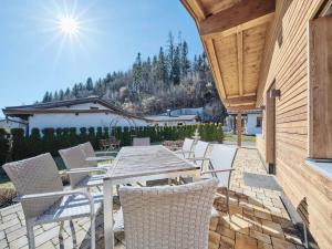 a patio with a table and chairs on a building at Ferienhaus 12 im Feriendorf Kirchdorf in Kirchdorf in Tirol