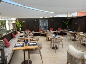 a restaurant with wooden tables and chairs in a room at Hotel Zen Airport in Torremolinos