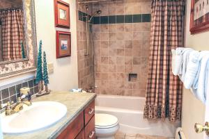 a bathroom with a sink and a toilet and a shower at Fawn Valley Inn- 240 condo in Estes Park +3 photos