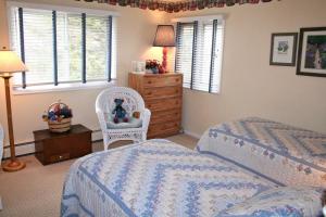 a bedroom with two beds and a dresser at Fawn Valley Inn- 240 condo in Estes Park