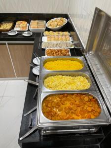 a buffet line with many different types of food at Abolição Praia Hotel in Fortaleza