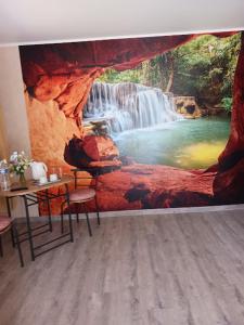 a room with a waterfall mural on the wall at Aquadetente loudeac in Loudéac