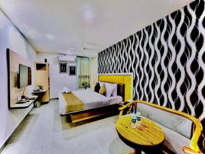 a bedroom with a bed and a couch and a table at Hotel Lake View Airport zone in Hyderabad