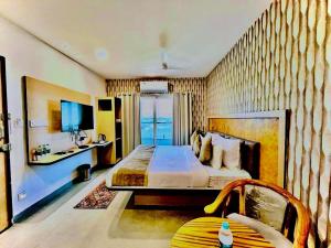 a hotel room with a bed and a television at Hotel Lake View Airport zone in Hyderabad