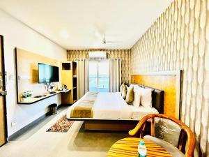 a hotel room with a bed and a balcony at Hotel Lake View Airport zone in Hyderabad