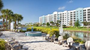 a park with chairs and a fountain in front of a building at Bluegreen Vacations The Fountains, Ascend Resort Collection in Orlando