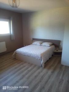 a bedroom with a bed and a window at Aquadetente loudeac in Loudéac