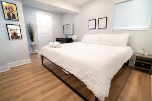1 dormitorio con 1 cama grande con sábanas blancas en Chic & Stylish Fully Renovated Central Location, en Tampa