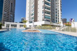- une grande piscine dans un bâtiment avec de grands bâtiments dans l'établissement 360 Summit Pinheiros, à São Paulo