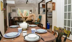 a wooden table with plates and a vase on it at Marvelous 3BR in NYC! in New York