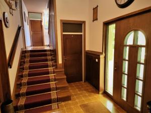 a hallway with stairs leading to a door at Tourist house Capricorn in Bled