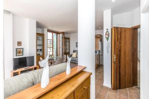 a living room with a couch and a tv at EDEN RENTALS Seaside Getaway in Puerto de Santiago