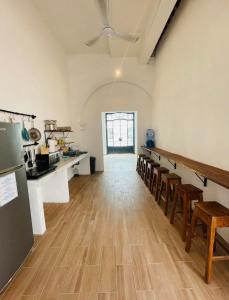 a large room with a kitchen with wooden floors at Bleu Downtown in Campeche