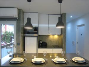 a kitchen with a table with plates and wine glasses at Cascais FEELINGS in Cascais
