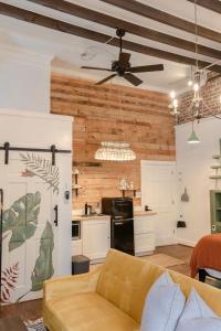 a living room with a couch and a kitchen at 1885 Garden Studio - Historic Heart of Savannah - Pulaski Ward in Savannah