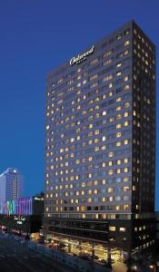 a tall building with a sign on top of it at Oakwood Premier Coex Center in Seoul