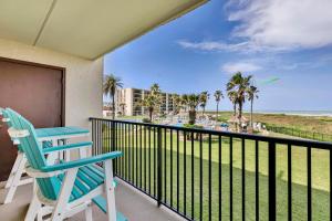 a blue chair sitting on a balcony with a view of the beach at Ocean view condo in resort with all the amenities! in South Padre Island