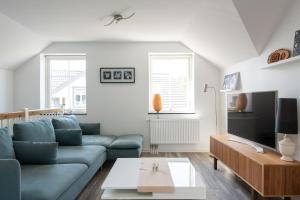 a living room with a couch and a table at The Rose Valley room in a shared villa in Gothenburg