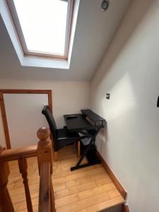 einen schwarzen Schreibtisch in einem Zimmer mit Fenster in der Unterkunft Luxury Home in Dublin WiFi TV B&B Close to City Centre in Lucan