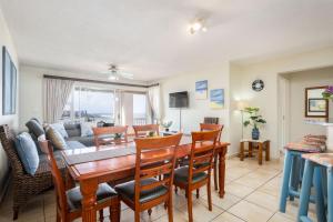 a dining room and living room with a table and chairs at Laguna La Crete 44 in Uvongo Beach
