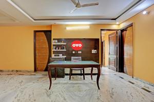 a dining room with a table and a sign on the wall at OYO Flagship Naveen Stay 2 in Gurgaon