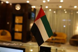 a flag sitting on top of a glass table at THE K HOTEL in Dubai