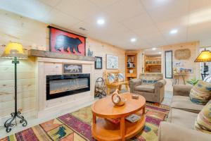 a living room with a fireplace and a couch at Secluded Murphy Vacation Rental with Private Hot Tub in Murphy