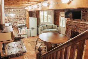 Cabaña con cocina y sala de estar con mesa. en Couples Serenity Cabin Waterfall Lake, en Milford