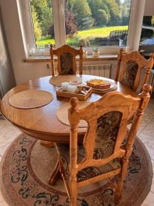 een houten tafel met een bord eten erop bij Dom w górach in Koszarawa