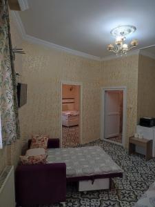 a living room with a table and a bedroom at Old City Pansiyon in Istanbul