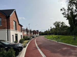 a residential street with cars parked on the side of the road at 3 bed rooms Vip family house in Dublin