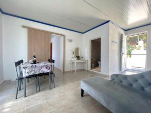 a living room with a table and a couch at Paradis Studios in Archangelos