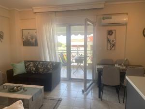 a living room with a couch and a table at Kalliopi Deluxe Apartment in Perea