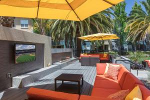 a patio with orange furniture and yellow umbrellas at Sunnyvale 1BR w wd gym pool nr highways SFO-1111 in Sunnyvale