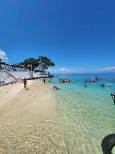 a group of people in the water on a beach at Bora Bora Beach Club & Hotel in Isla Grande