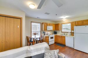 a kitchen with a table and a white refrigerator at Morgantown Apartment Near Hospitals 1 Mi to WVU! in Morgantown
