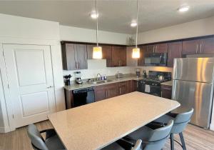 a kitchen with a table and a refrigerator at Luxury Condo in the Best Part of Downtown in Salt Lake City