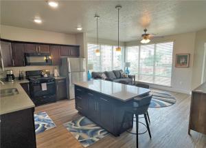 a large kitchen and living room with a counter top at Luxury Condo in the Best Part of Downtown in Salt Lake City