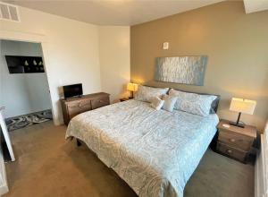 a bedroom with a large bed and two night stands at Luxury Condo in the Best Part of Downtown in Salt Lake City