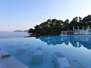 a swimming pool with a view of the ocean at Excelsior Palace Hotel in Rapallo