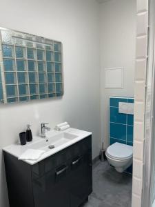 a bathroom with a sink and a toilet at Apartment 3 confort&modern in Arad