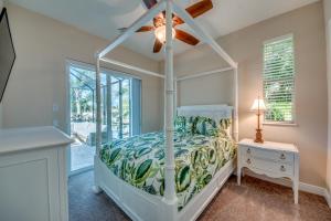 a bedroom with a bed and a ceiling fan at Villa Mayfair, Cape Coral in Cape Coral +40 photos