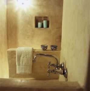 a bathroom with a sink with a towel at Dar Lazuli Bed & Breakfast in Essaouira