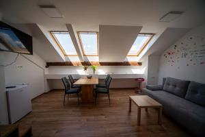 a living room with a table and a couch at Sport apartments in Radovljica