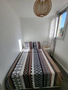 a bedroom with a large bed in a room at Pépite entre Paris et Versailles in Chaville