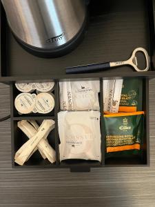 a drawer with a pot and a pair of scissors at SPREE. Hotel am Hafen in Lübbenau