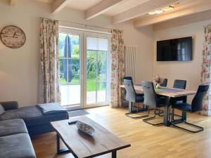 a living room with a table and a couch at Lohme - Doppelhaushälfte Svantevit 2 in Ranzow in Ranzow
